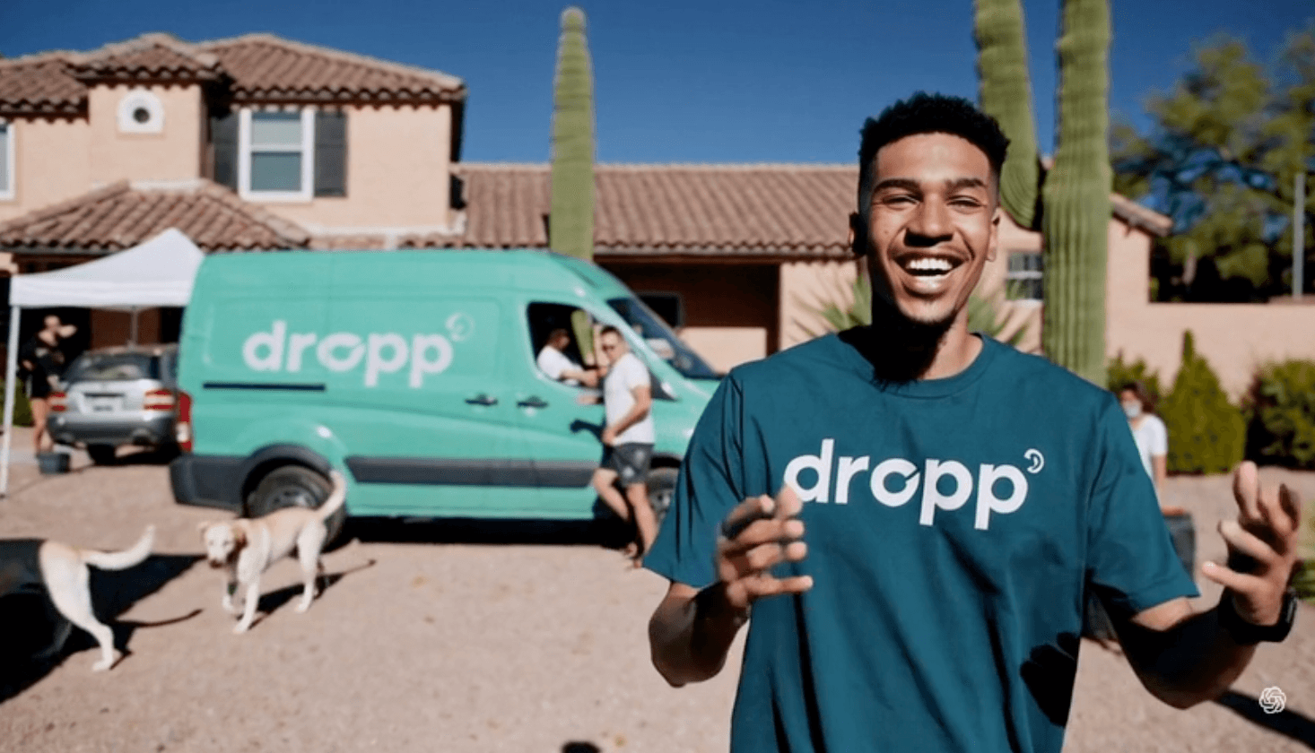 Happy DROPP team member in Arizona with company van and desert landscape